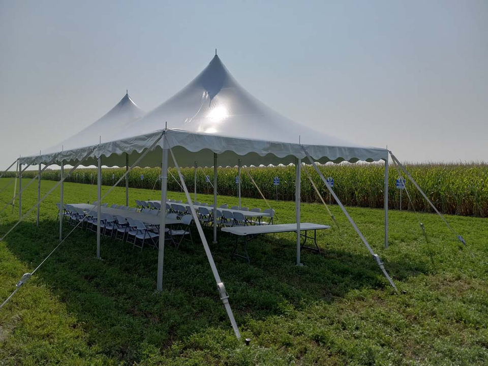 Large peaked tent set up for an outdoor celebration on the Great Plains